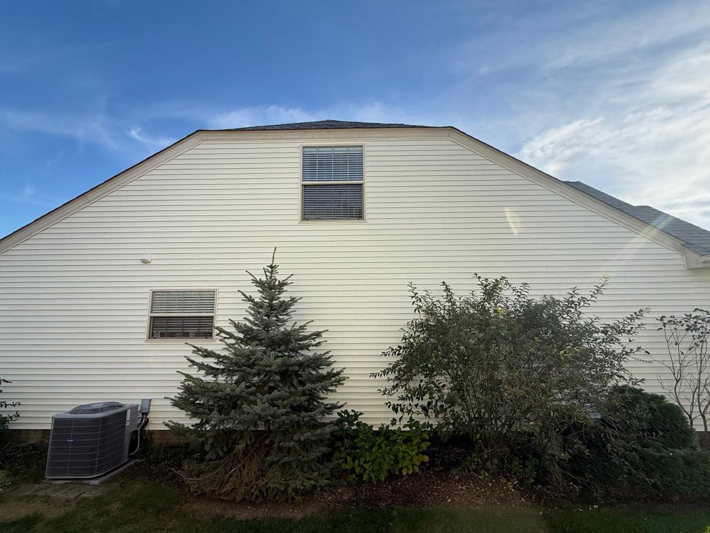 A home exterior soft washed clean of algae by Core Exterior Services