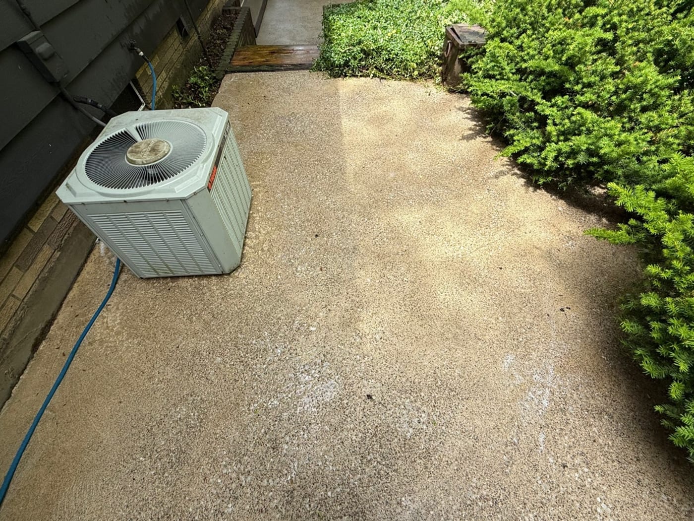 A concrete pad with the moss and staining washed away by Core Exterior Services